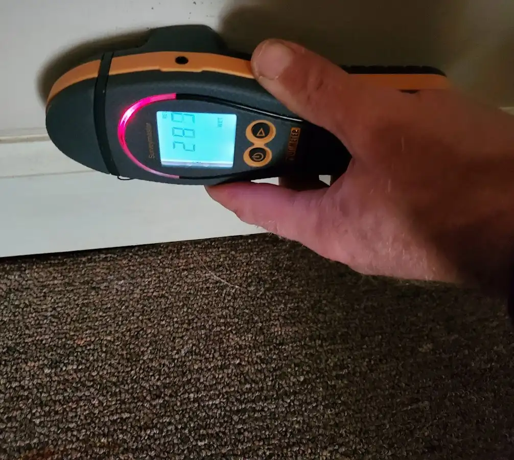 Moisture detection at baseboard during Storm Damage Restoration in Tomah